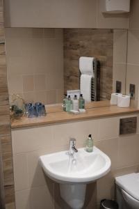 a bathroom with a sink and a mirror at Craigmhor Lodge & Courtyard in Pitlochry +77 photos