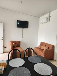 a living room with a table and chairs and a couch at Marsella Rest House in Sitio del Niño