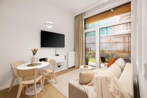 a living room with a couch and a table at City Break Śląska 8 by INA in Gdańsk
