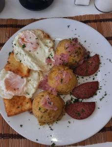 a white plate of food with scallops and meat at Sunshine Hotel - Puerto Plata in San Felipe de Puerto Plata +34 photos