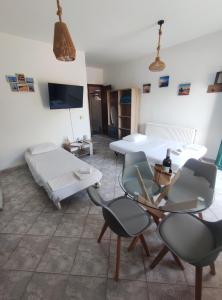 a room with two beds and a table and chairs at A & K Vacation House in Város +17 photos