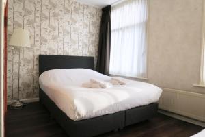 Postel nebo postele na pokoji v ubytování Hotel Carillon