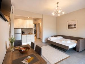 a living room with a bed and a kitchen at Danita Apartments in Paleros