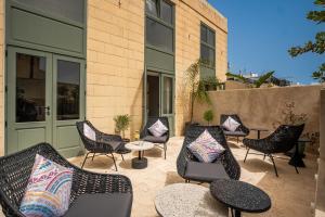 a group of chairs and tables on a patio at The Three Doors in St. Julianʼs
