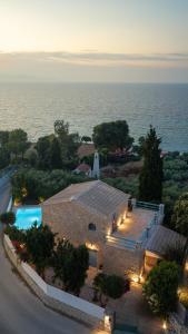 an aerial view of a house with a swimming pool at Kyanorama Villa, A Seaside Escape in Tragaki