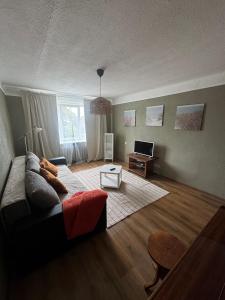 a living room with a couch and a table at Sunset Stay in Kolka in Kolka