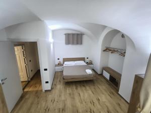 a bedroom with a bed in a white room at La Casa di Lu & Li in Subiaco +12 photos