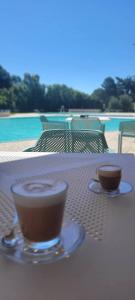 two cups of coffee sitting on top of a table at Grazioso monolocale Isola d'Elba in Capo D'Arco