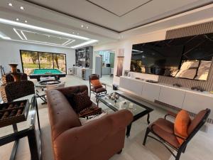 a living room with a couch and a pool table at Villa Donatella Bonao in Bonao