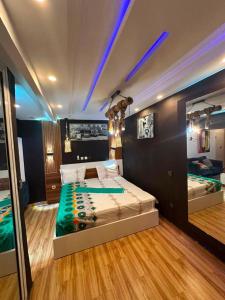 a bedroom with a large bed with blue lights at Résidence kone daouda in Abidjan