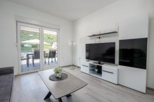 a living room with a large flat screen tv at Villa Nature in Čapljina