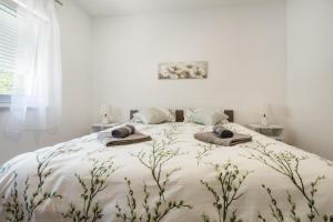 a white bedroom with a large bed with towels on it at Villa Nature in Čapljina +28 photos