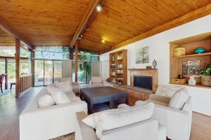 a living room with white couches and a fireplace at Poolside Oasis! Phoenix Group Sanctuary w/ Patio in Phoenix