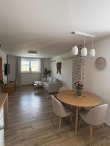 a living room with a table and a couch at Azyl na statku 5 in Pardubice