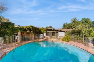 a large blue swimming pool with a fence at Poolside Oasis! Phoenix Group Sanctuary w/ Patio in Phoenix