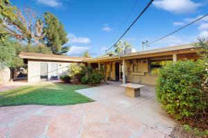a house with a bench in front of it at Poolside Oasis! Phoenix Group Sanctuary w/ Patio in Phoenix