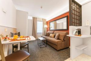 a living room with a couch and a table at Acacia Suite in Barcelona
