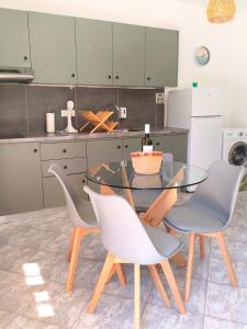 a kitchen with a glass table and chairs at A & K Vacation House in Város