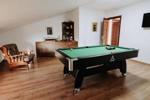 a living room with a pool table in it at Domeniul H in Rişca