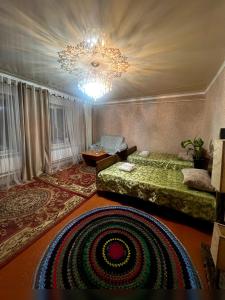 a bedroom with a bed and a chandelier at Azamat in Kara-Koo