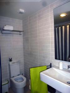 a bathroom with a white toilet and a sink at CASAS MARE , Ponta Delgada, Madeira in Ponta Delgada