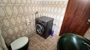 a washing machine in a bathroom with a toilet at Grandma Luísa's Corner in Verdelhos