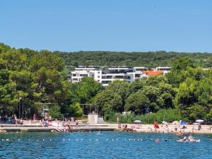 a group of people in the water at a beach at Casagrande in Krk