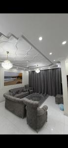 a living room with two couches and a bed at Sea Breeze Ras Al Hadd in Sur