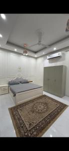 a bedroom with a bed and a rug on the floor at Sea Breeze Ras Al Hadd in Sur