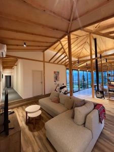 a living room with a couch and a table at Amper Villa Dilijan in Dilijan