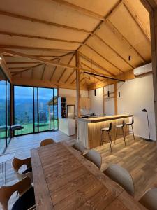 a large room with a wooden table and a kitchen at Amper Villa Dilijan in Dilijan
