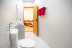 a bathroom with a toilet and a sink and a door at Hola Rio in Dakhla +27 photos