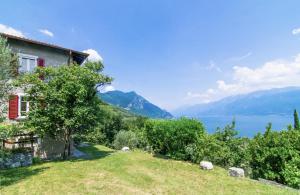 a house with a view of the lake and mountains at Villa Supina - 3BDR with Pool & Panoramic Lake Garda Views in Toscolano Maderno