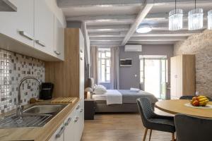 a kitchen with a sink and a bed in a room at Studio apartman Oreb in Vela Luka