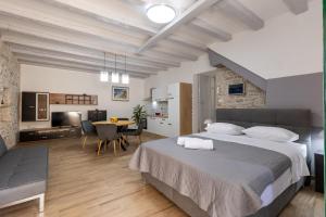 a bedroom with a large bed and a dining room at Studio apartman Oreb in Vela Luka