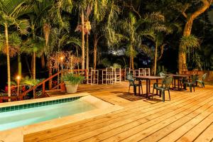 a deck with a table and chairs and a pool at Colonial Suite @ Mahogany Hall in San Ignacio