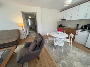 a kitchen and a living room with a table and chairs at Urla Garden House in Urla +27 photos