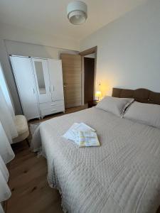 a bedroom with a white bed with a towel on it at Urla Garden House in Urla