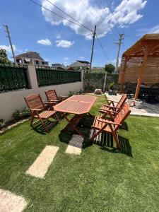 a picnic table and chairs on the grass at Urla Garden House in Urla