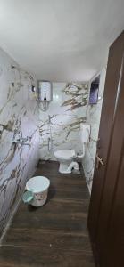 a bathroom with a toilet and a sink at Tuljapur Bhaktaniwas in Tuljapur