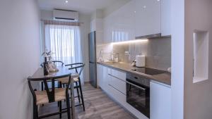 a kitchen with a table and two chairs and a counter at Orelia Suite 3 in Karistos
