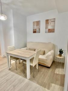 a living room with a table and a couch at San Roque 7 in Archidona