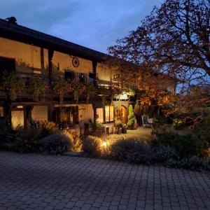 a large house with a courtyard at night at Berggasthof Immenstein in Bühl