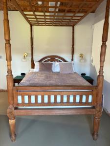 a bed with a wooden frame in a room at Agroturystyka Muraszkowa Zagroda in Giebułtów +25 photos