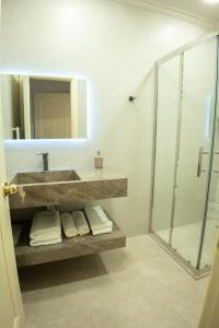 a bathroom with a sink and a glass shower at Gala Terrace Hotel & Restaurant in Baku