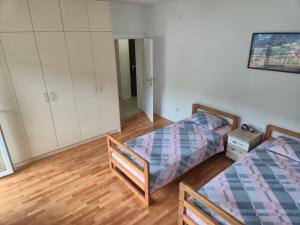 a bedroom with two beds and a closet at Drinika in Foča
