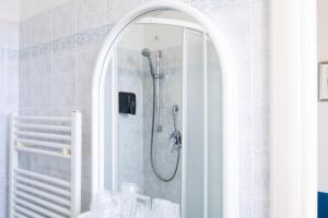 a shower in a bathroom with a mirror at Hotel Verbena in Lido di Camaiore +62 photos
