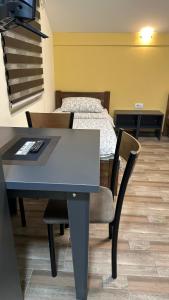 a table and chair in a room with a bed at Apartmani Kovačević MKM Banja Vrujci in Gunjica +131 photos