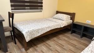 a small bedroom with a bed and a desk at Apartmani Kovačević MKM Banja Vrujci in Gunjica