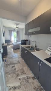 a kitchen with a sink and a counter top at Wide shore Apt in Kamári
